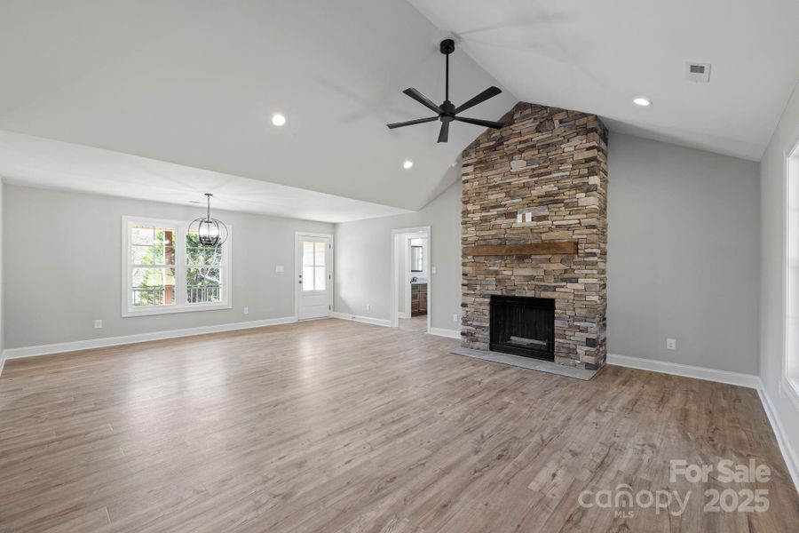 Vaulted ceilings, a stunning floor-to-ceiling stone fireplace, and abundant natural light—creating the perfect warm and inviting gathering space for family and friends! Vaulted ceilings, a stunning floor-to-ceiling stone fireplace, and abundant natural light—creating the perfect warm and inviting gathering space for family and friends!