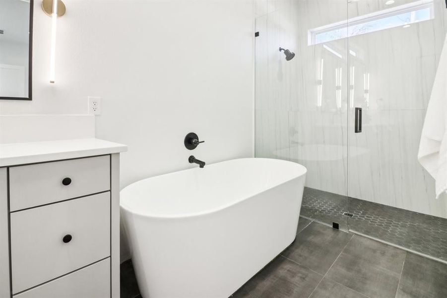 Bathroom with vanity and shower with separate bathtub