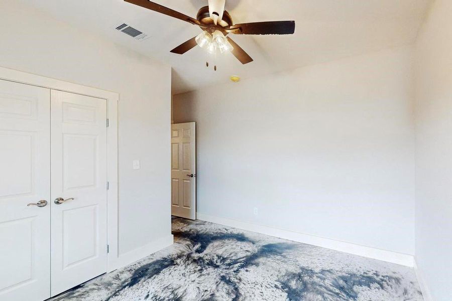 Bedroom featuring ceiling fan and a closet