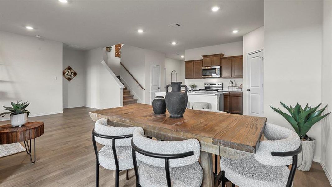 Dining area featuring light wood finished floors and recessed lighting