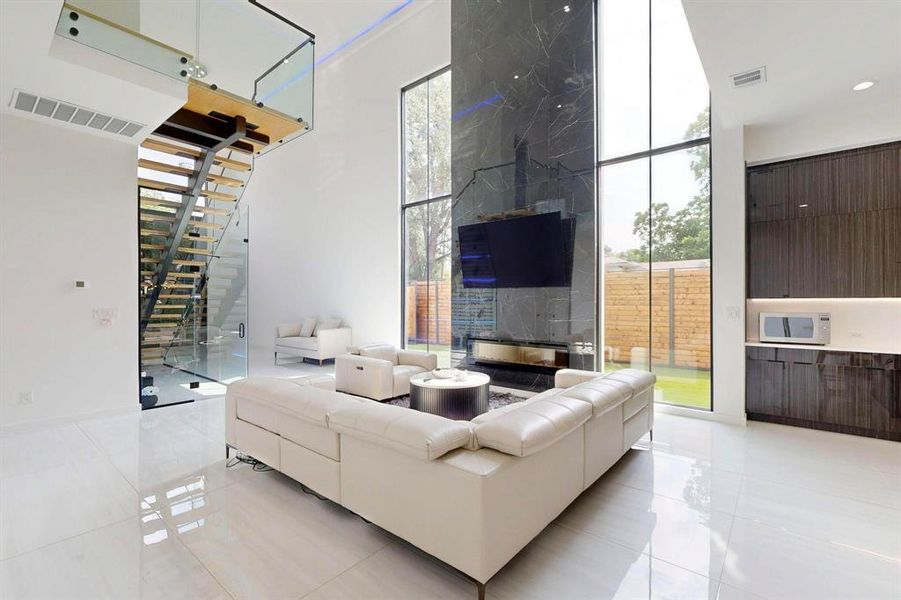 Living area with light tile patterned flooring, stairway, and healthy amount of natural light Living area with light tile patterned flooring, stairway, and healthy amount of natural light