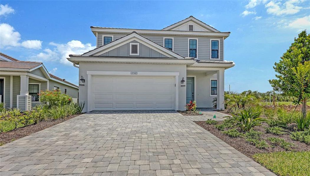 Front exterior of a new home in Palm Grove, Lakewood Ranch, FL, highlighting curb appeal (Image 2).