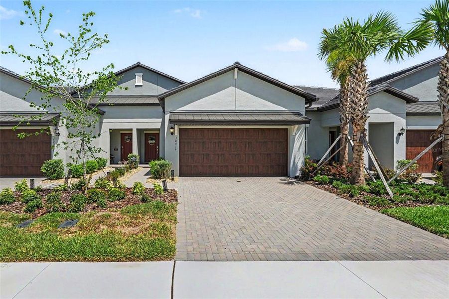 Front exterior of a new home in Angeline Active Adult, Land O' Lakes, FL, highlighting curb appeal (Image 2). Front exterior of a new home in Angeline Active Adult, Land O' Lakes, FL, highlighting curb appeal (Image 2).