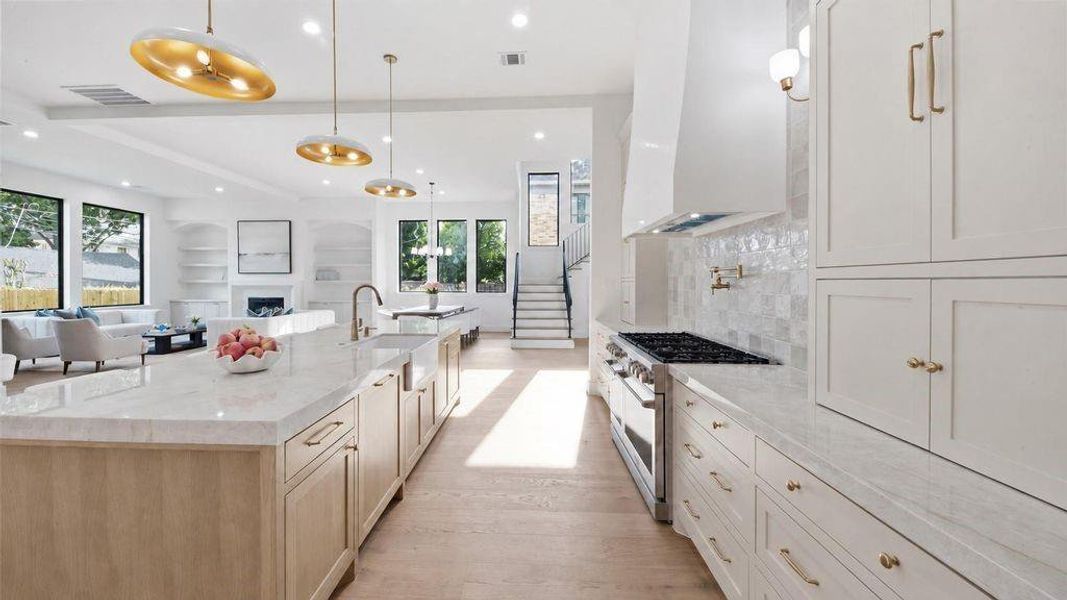 view of extensive kitchen storage with views into the living room and dining room perfect for entertianing and families