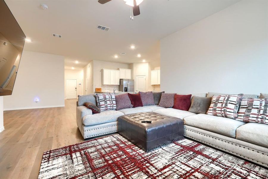 Living area featuring light wood-style floors, a ceiling fan, and recessed lighting Living area featuring light wood-style floors, a ceiling fan, and recessed lighting