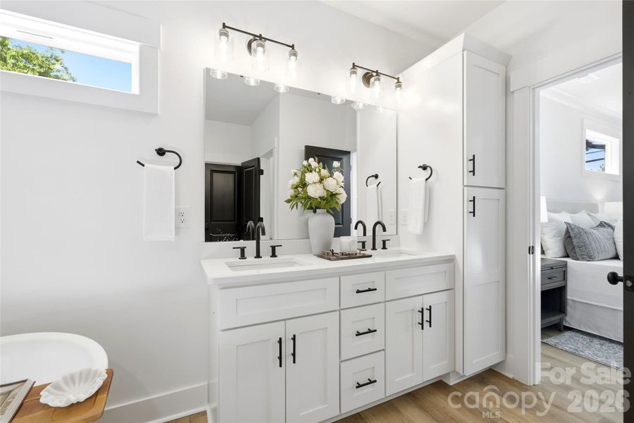 A true retreat with dual vanities, additional built-in storage