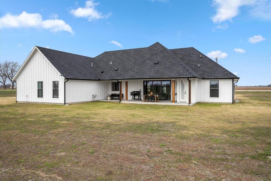 Back of house featuring a patio area and a yard