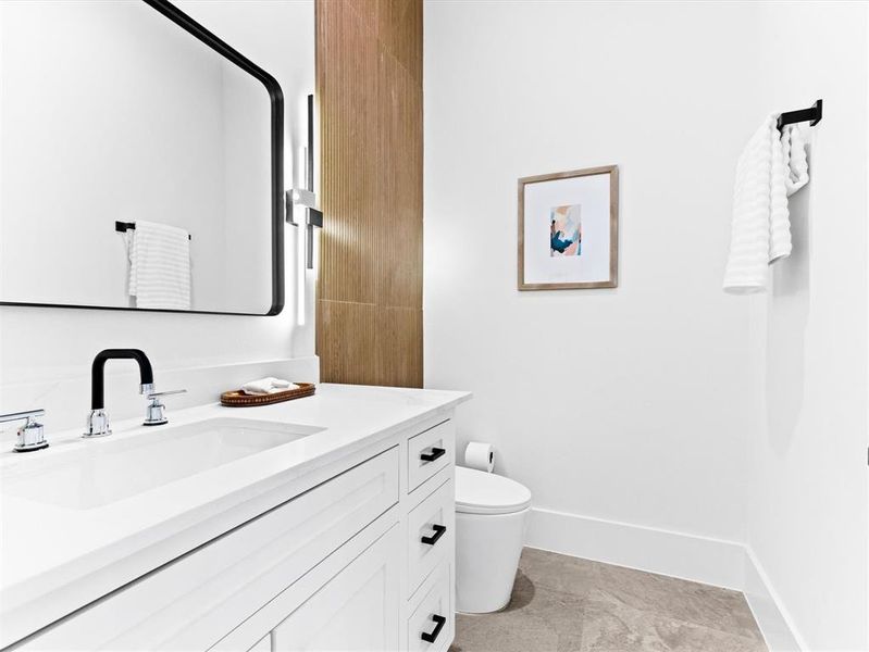 Bathroom with tile flooring, toilet, and vanity