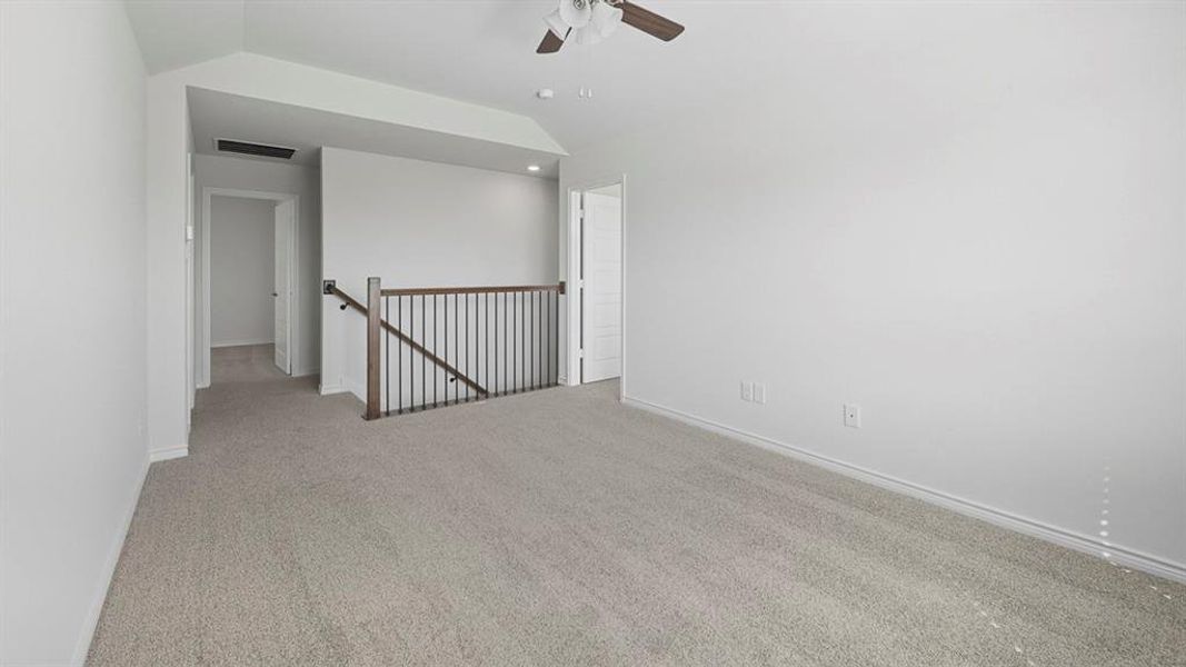 Unfurnished room with vaulted ceiling, carpet floors, and ceiling fan