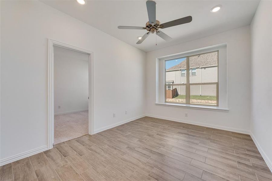 Spare room featuring light wood-type flooring and ceiling fan