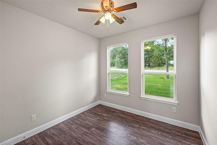 Spare room with ceiling fan and hardwood / wood-style floors