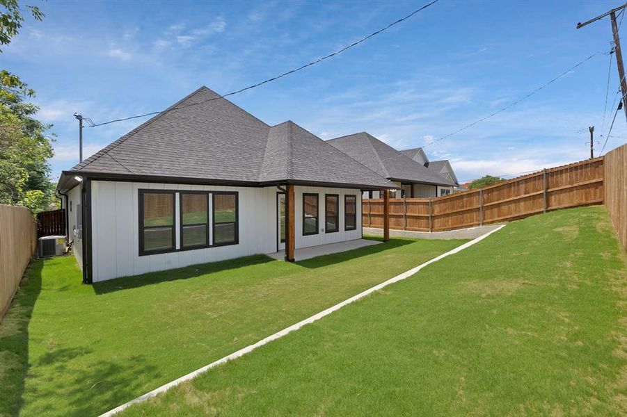 Rear view of property featuring central AC and roof with shingles Rear view of property featuring central AC and roof with shingles