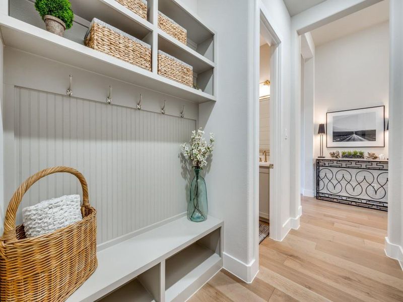 Mudroom featuring light wood finished floors and baseboards