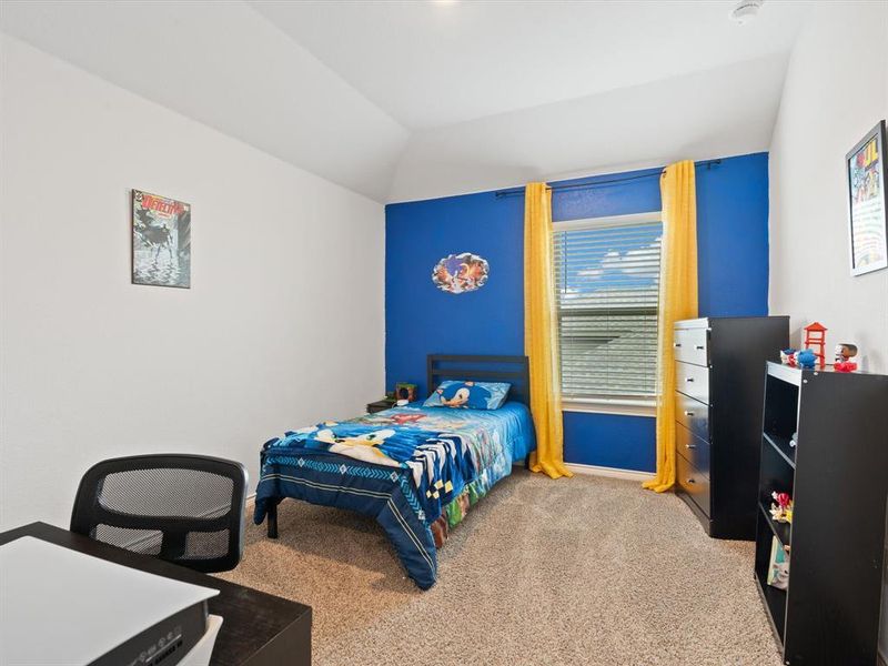 Bedroom featuring vaulted ceiling and light colored carpet