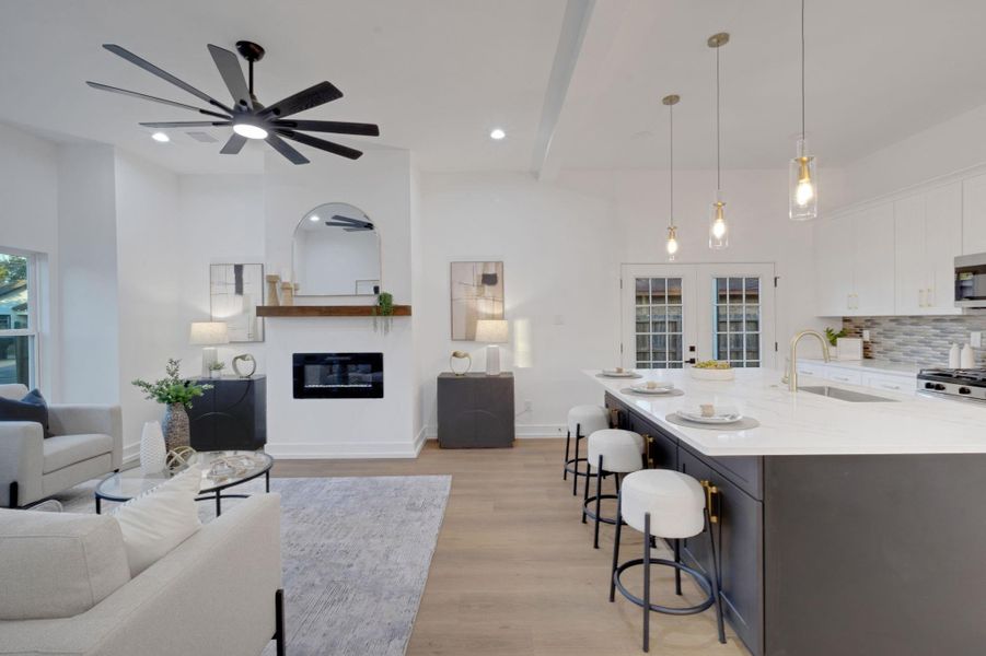 Bright and airy living space with open-concept design, modern ceiling fan, and seamless flow into the kitchen. Bright and airy living space with open-concept design, modern ceiling fan, and seamless flow into the kitchen.