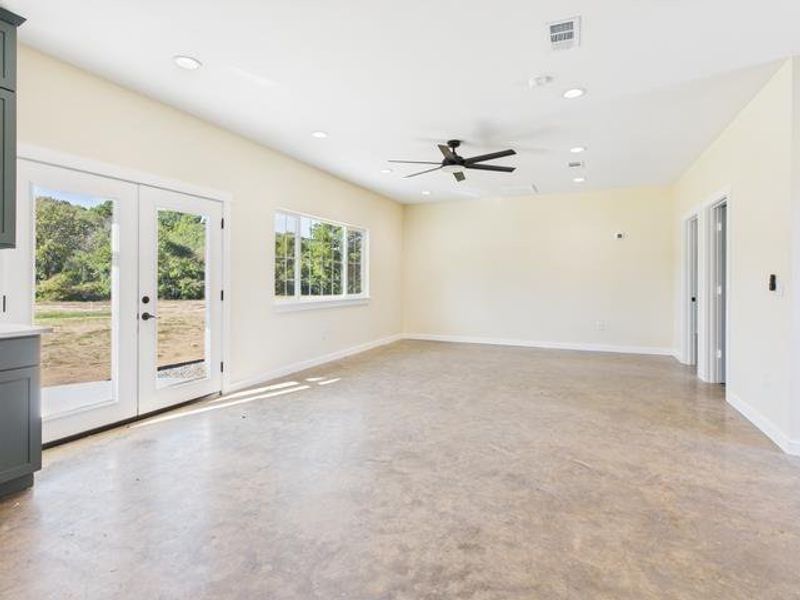 Before photo  french doors, recessed lighting, and ceiling fan