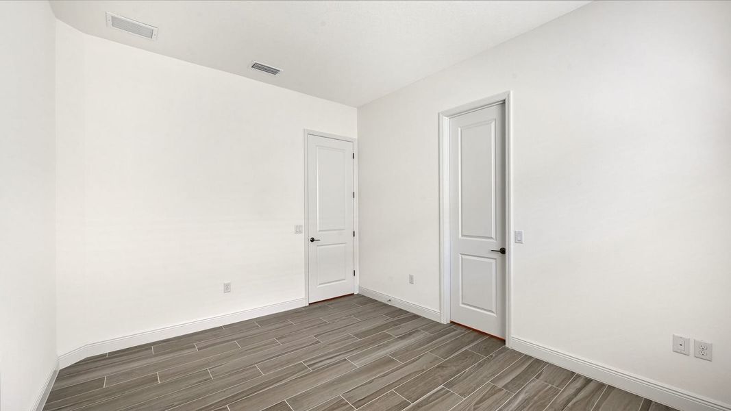 Spacious, unfurnished interior of a new home in Palm Grove Real Estate and Homes for Sale in Lakewood Ranch, FL - Neal Communities, Bradenton (Image 31).