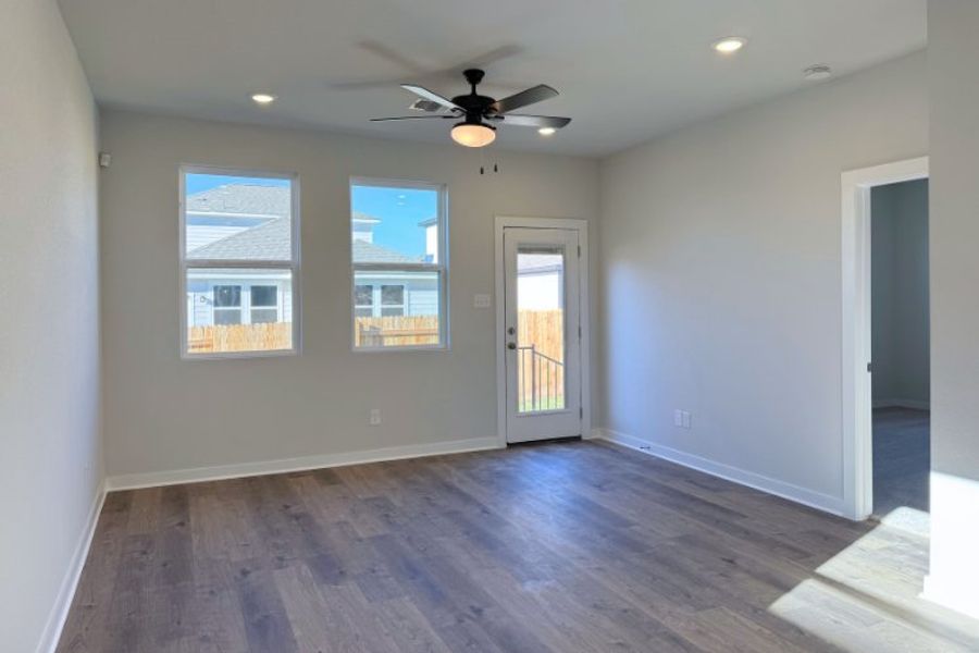 A room with a wood floor and a ceiling fan and a wood floor. A room with a wood floor and a ceiling fan and a wood floor.