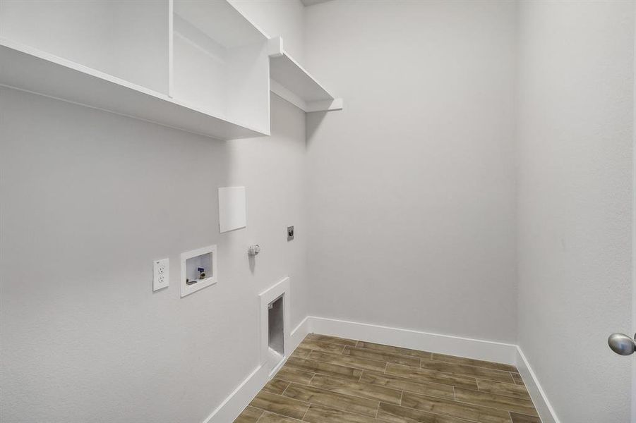 Laundry room with washer hookup, hookup for a gas dryer, dark wood-type flooring, and electric dryer hookup