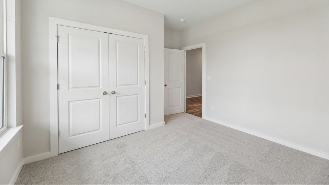 Bedroom with carpet and closet