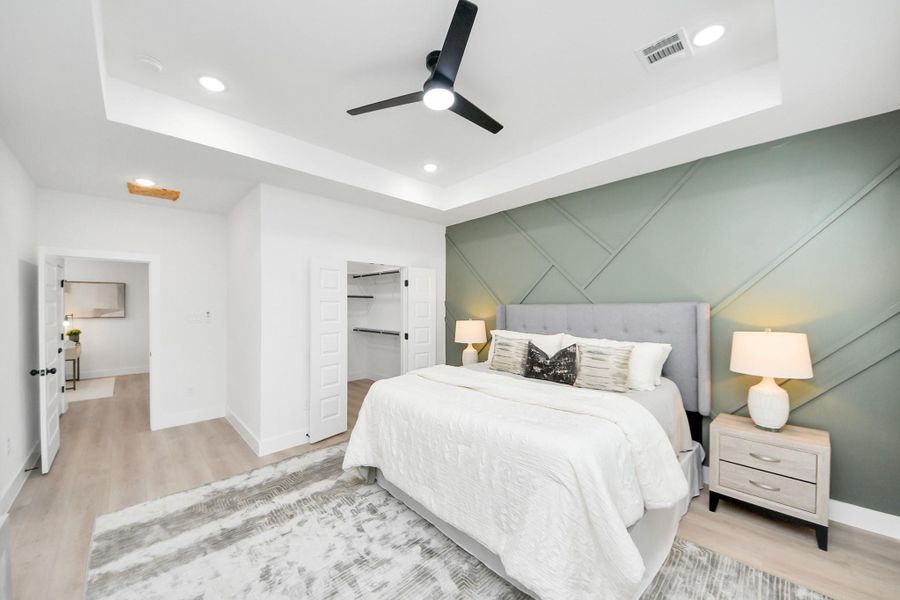 Spacious primary suite with tray ceiling and abundant natural light. Spacious primary suite with tray ceiling and abundant natural light.