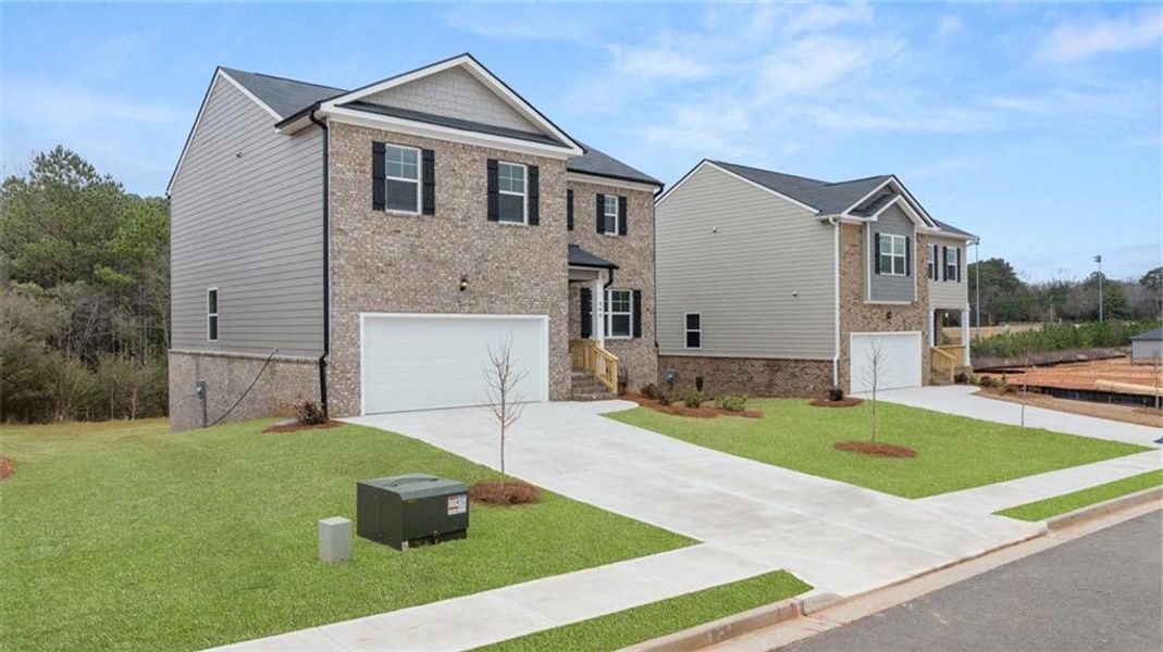 Front exterior of a new home in The Reserve at Calcutta, Stockbridge, GA, highlighting curb appeal (Image 1).
