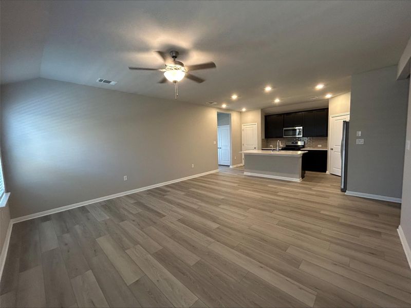 Unfurnished living room with recessed lighting, light wood finished floors, and a ceiling fan Unfurnished living room with recessed lighting, light wood finished floors, and a ceiling fan