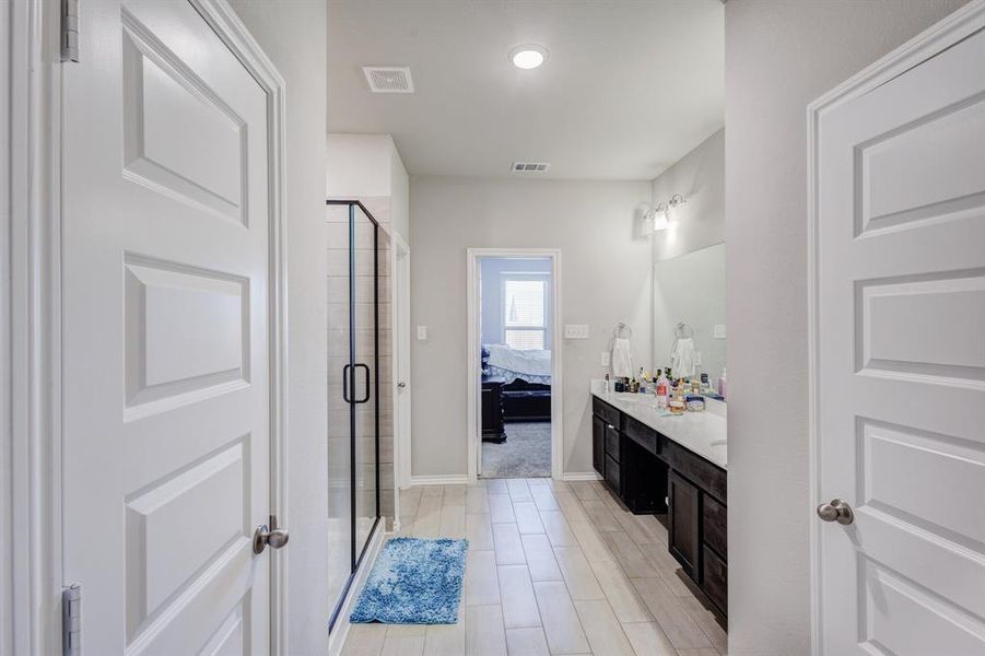 Full bath with vanity, connected bathroom, and a shower stall Full bath with vanity, connected bathroom, and a shower stall