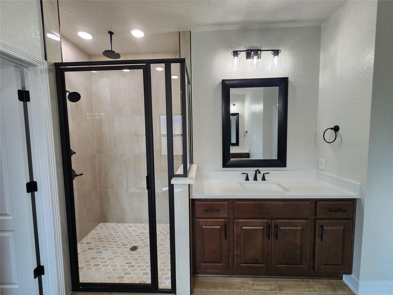 A well-appointed bathroom features a spacious walk-in shower and a modern vanity with ample counter space. A well-appointed bathroom features a spacious walk-in shower and a modern vanity with ample counter space.
