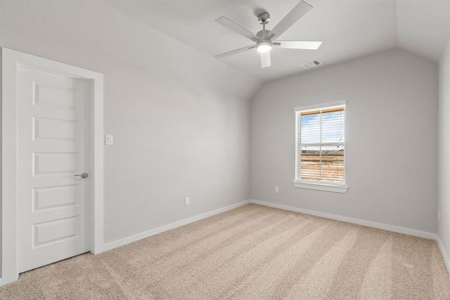 Elegance meets functionality in the secondary bedrooms, showcasing 5-panel doors with modern hardware, large windows adorned with privacy blinds, and walk-in closets boasting sleek and contemporary finishes. Sample photo of completed home with similar floor plan. Actual colors and selections may vary.