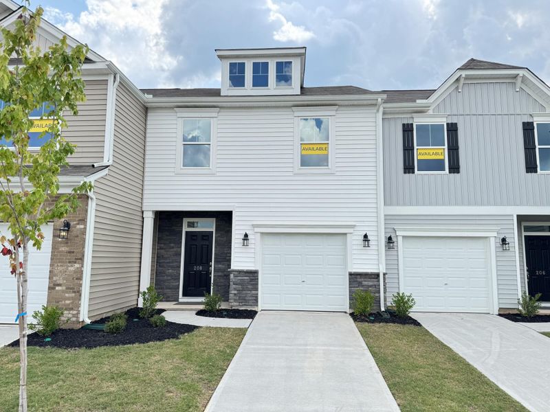 Front exterior of a new home in Bellevue Townhomes, Greenville, SC, highlighting curb appeal (Image 1).
