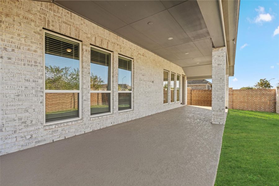 Panoramic view of the Extended Covered Patio and the beautiful brick exterior—your private outdoor living room.