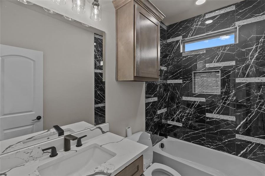 Full bath featuring vanity, toilet, and bathtub / shower combination