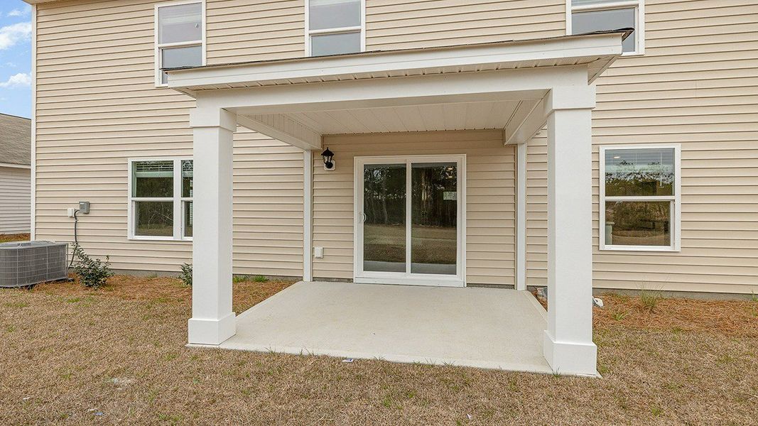 Front exterior of a new home in The Meadows at Wildwood Village, Shallotte, NC, highlighting curb appeal (Image 16).