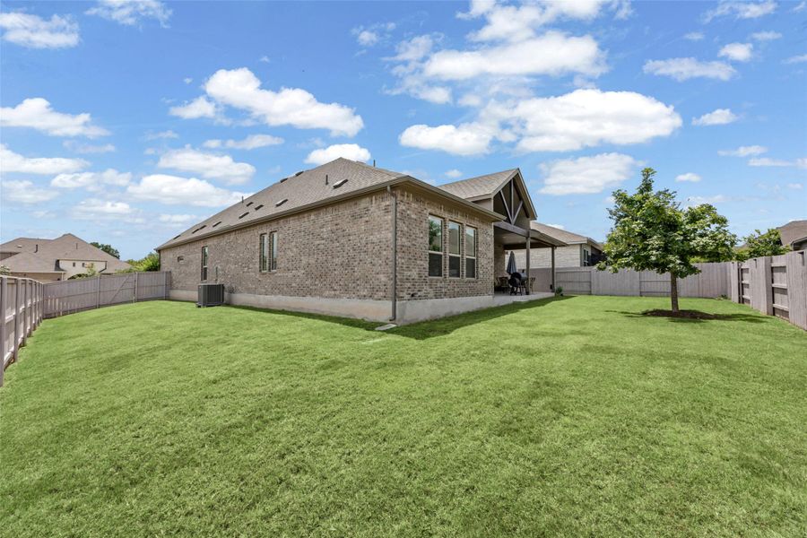 A verdant lawn wraps around this brick residence, offering ample outdoor living space. A verdant lawn wraps around this brick residence, offering ample outdoor living space.