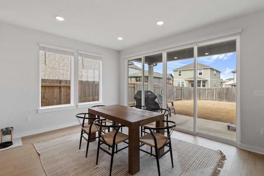 Dining room featuring a sliding glass door adding plenty of natural light, recessed lighting