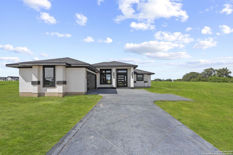 Front exterior of a new home in , Floresville, TX, highlighting curb appeal (Image 29). Front exterior of a new home in , Floresville, TX, highlighting curb appeal (Image 29).