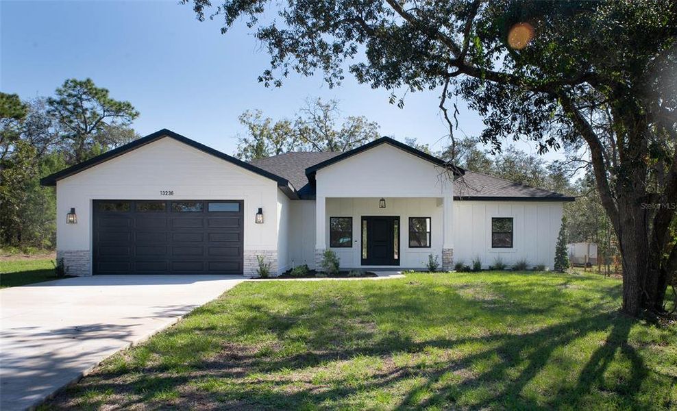 Front exterior of a new home in , Weeki Wachee, FL, highlighting curb appeal (Image 1).