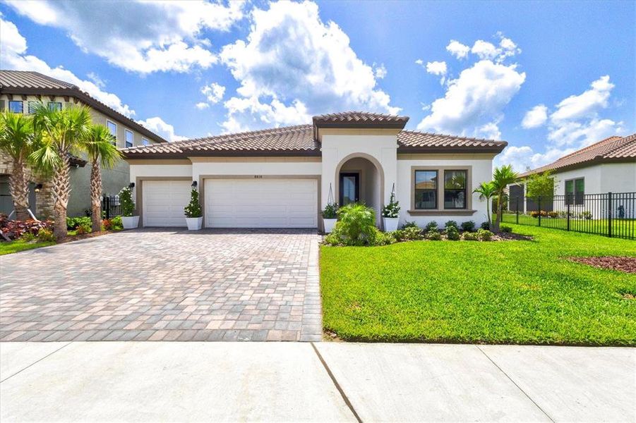 Front exterior of a new home in Crosswind Ranch, Parrish, FL, highlighting curb appeal (Image 25).