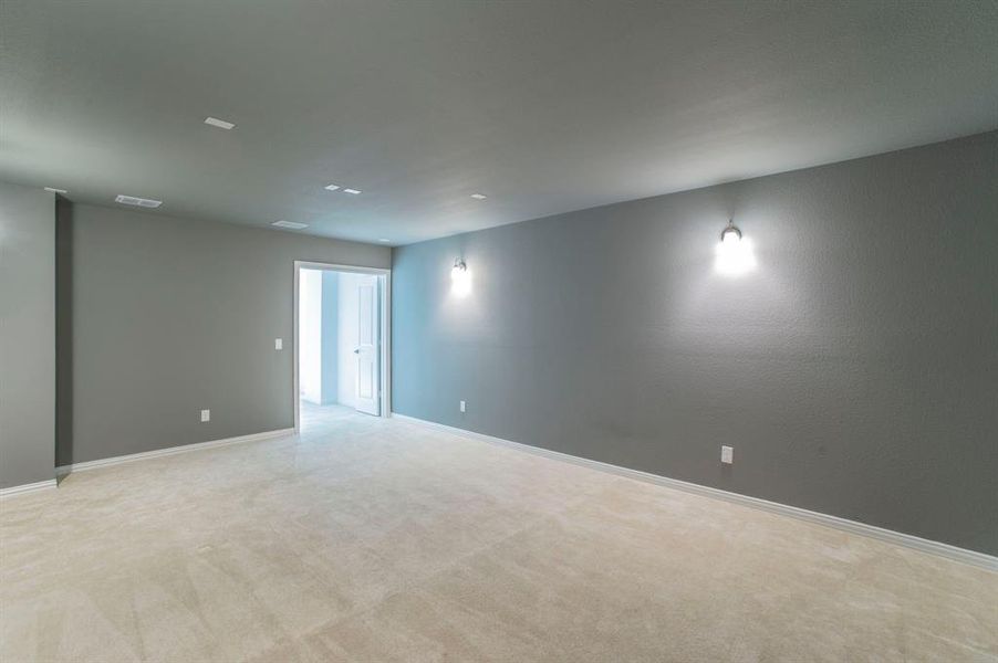 Spare room featuring light carpet and baseboards Spare room featuring light carpet and baseboards