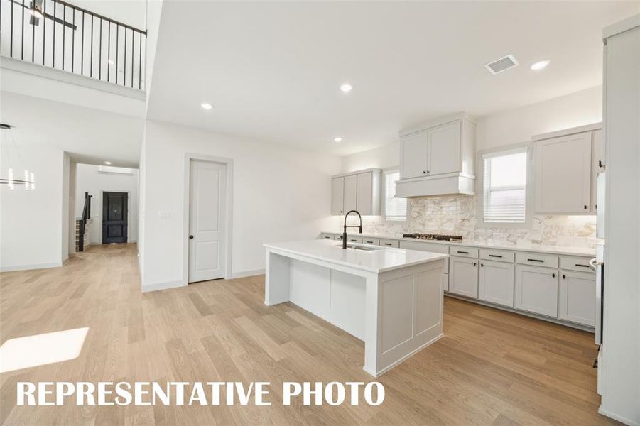 With a floor plan designed for entertaining, the chef in the family will never be left out of the party in this wonderful home!  REPRESENTATIVE PHOTO