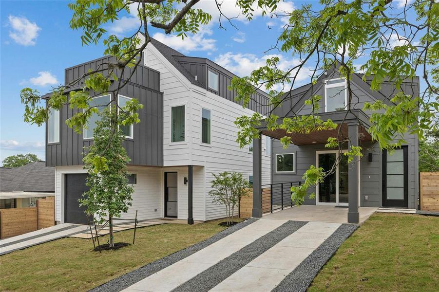Contemporary home featuring board and batten siding, driveway, and an attached garage