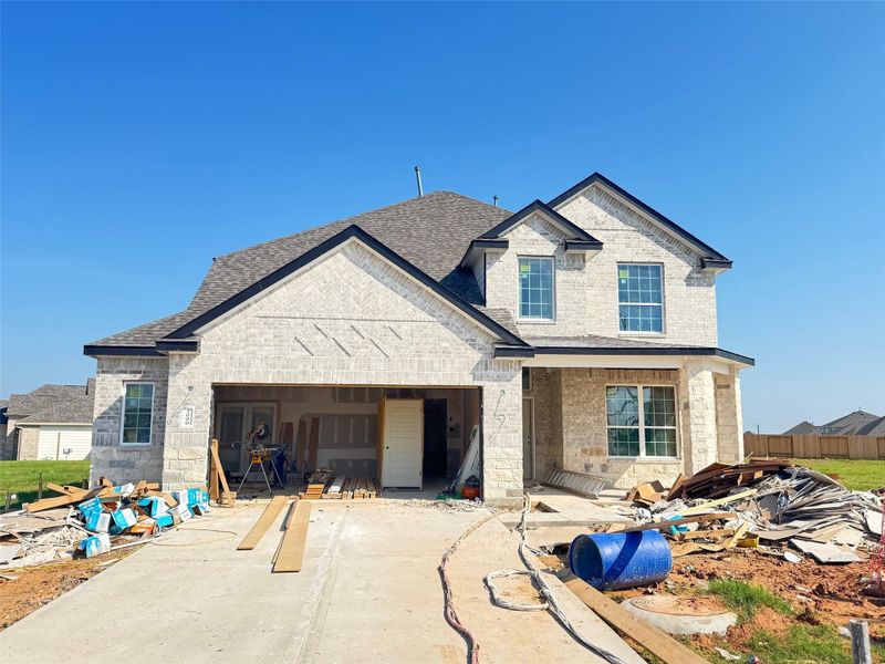 Front exterior of a new home in Bluestem, Brookshire, TX, highlighting curb appeal (Image 1). Front exterior of a new home in Bluestem, Brookshire, TX, highlighting curb appeal (Image 1).