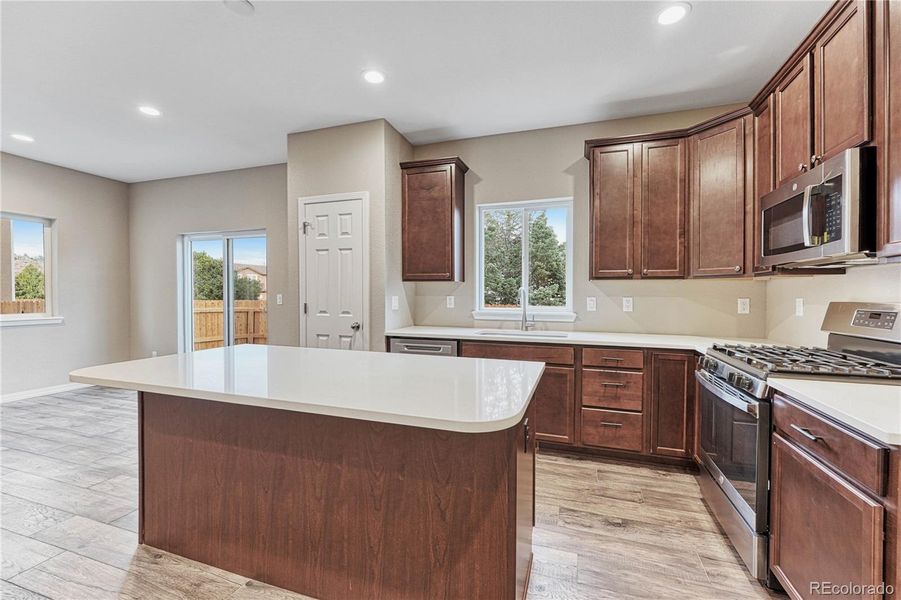 42" extended height cabinetry, stone countertops, optional pendant lighting, island, panty, and stainless steel appliances!