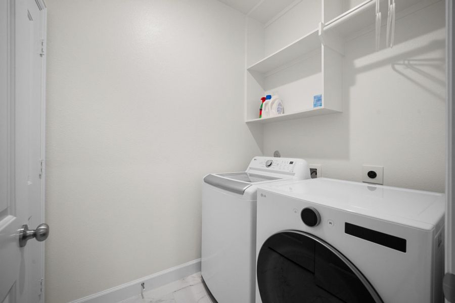 An upstairs utility room with full-size washer and dryer and built-in shelving above — laundry on the same floor as three of the four bedrooms is one of those things you don't appreciate until you have it. An upstairs utility room with full-size washer and dryer and built-in shelving above — laundry on the same floor as three of the four bedrooms is one of those things you don't appreciate until you have it.