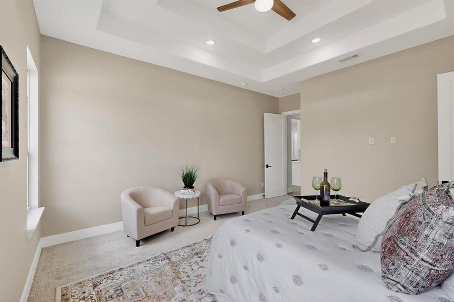 Bedroom with a raised ceiling, carpet, recessed lighting, and ceiling fan