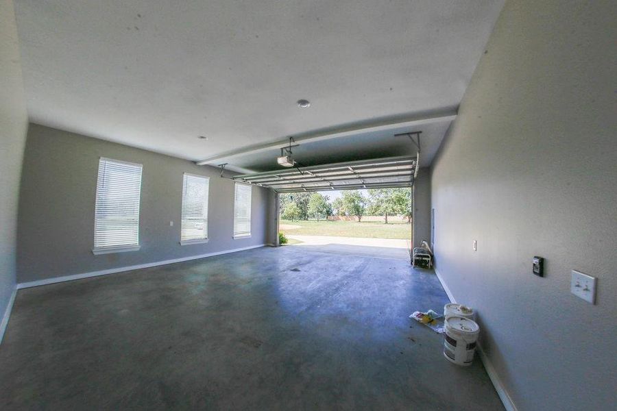 Garage featuring baseboards Garage featuring baseboards