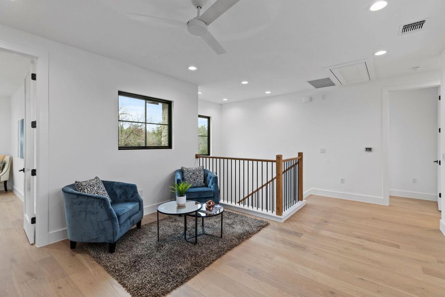 Sitting room featuring ceiling fan, light wood-style floors, recessed lighting, baseboards, and attic access