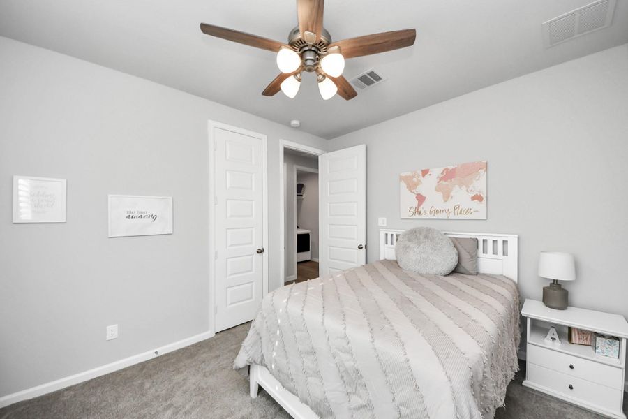 This cozy bedroom features soft gray walls, a ceiling fan. Ideal for a peaceful retreat. This cozy bedroom features soft gray walls, a ceiling fan. Ideal for a peaceful retreat.
