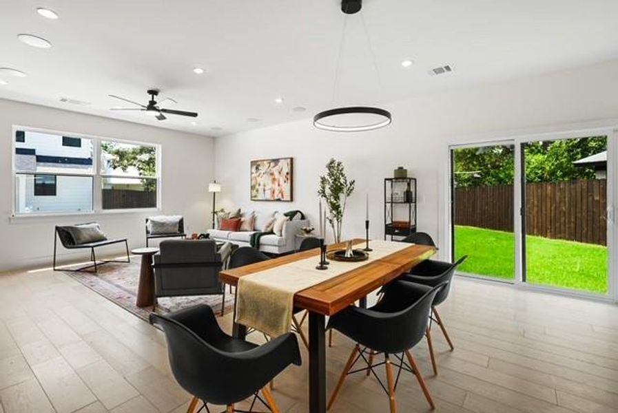 Dining room featuring recessed lighting, light wood-type flooring, healthy amount of natural light, and a ceiling fan